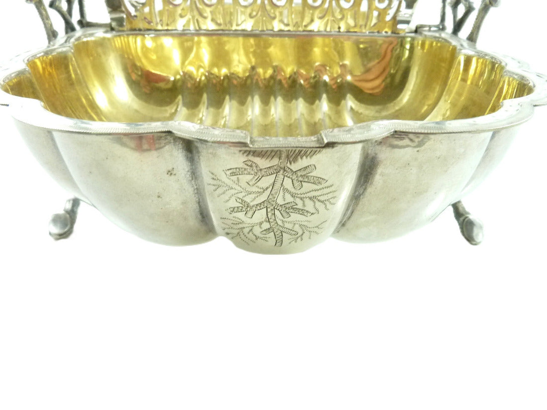 Close up of intricate hand-chased floral and scroll details on English silver biscuit box 