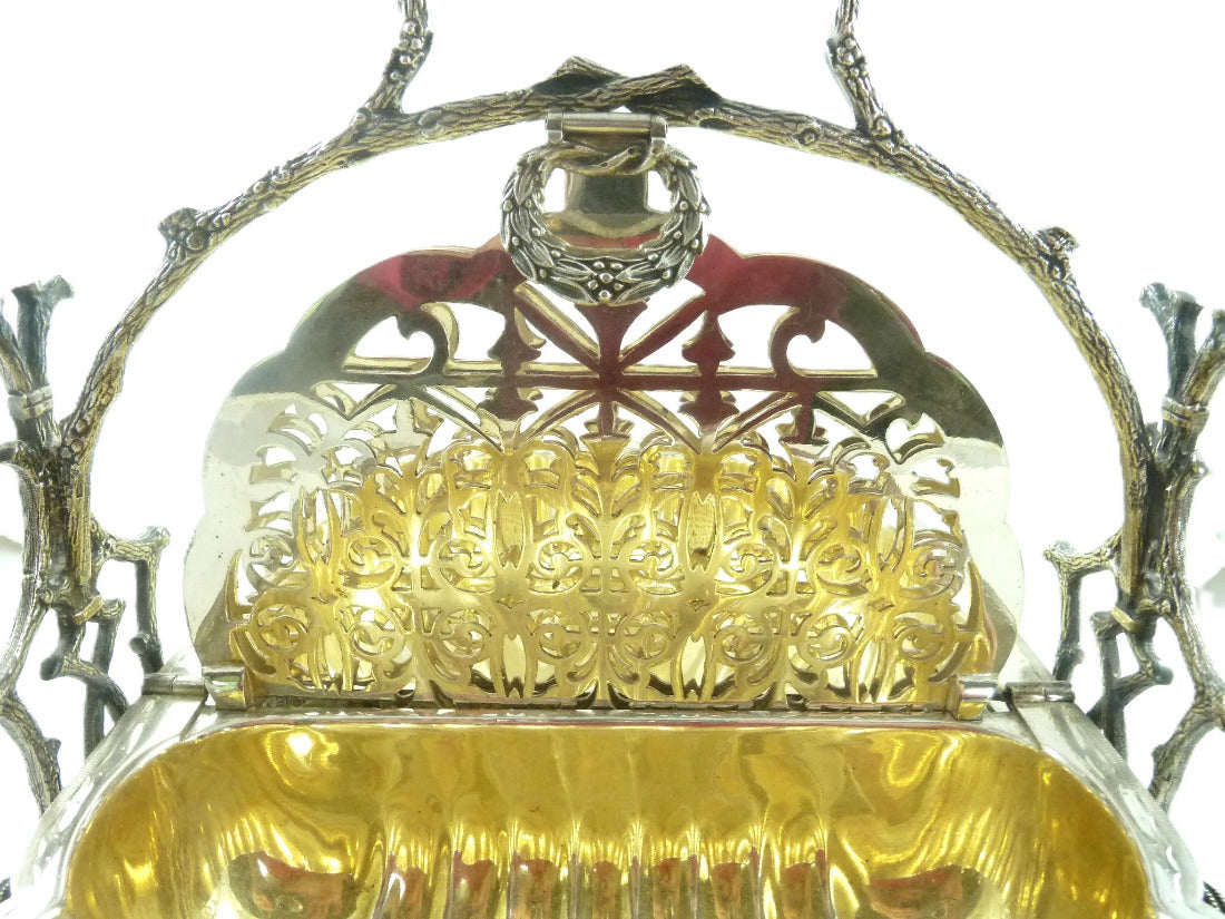 "Victorian silver plated biscuit warmer shown  open with interior pierced grills and gilt interior 